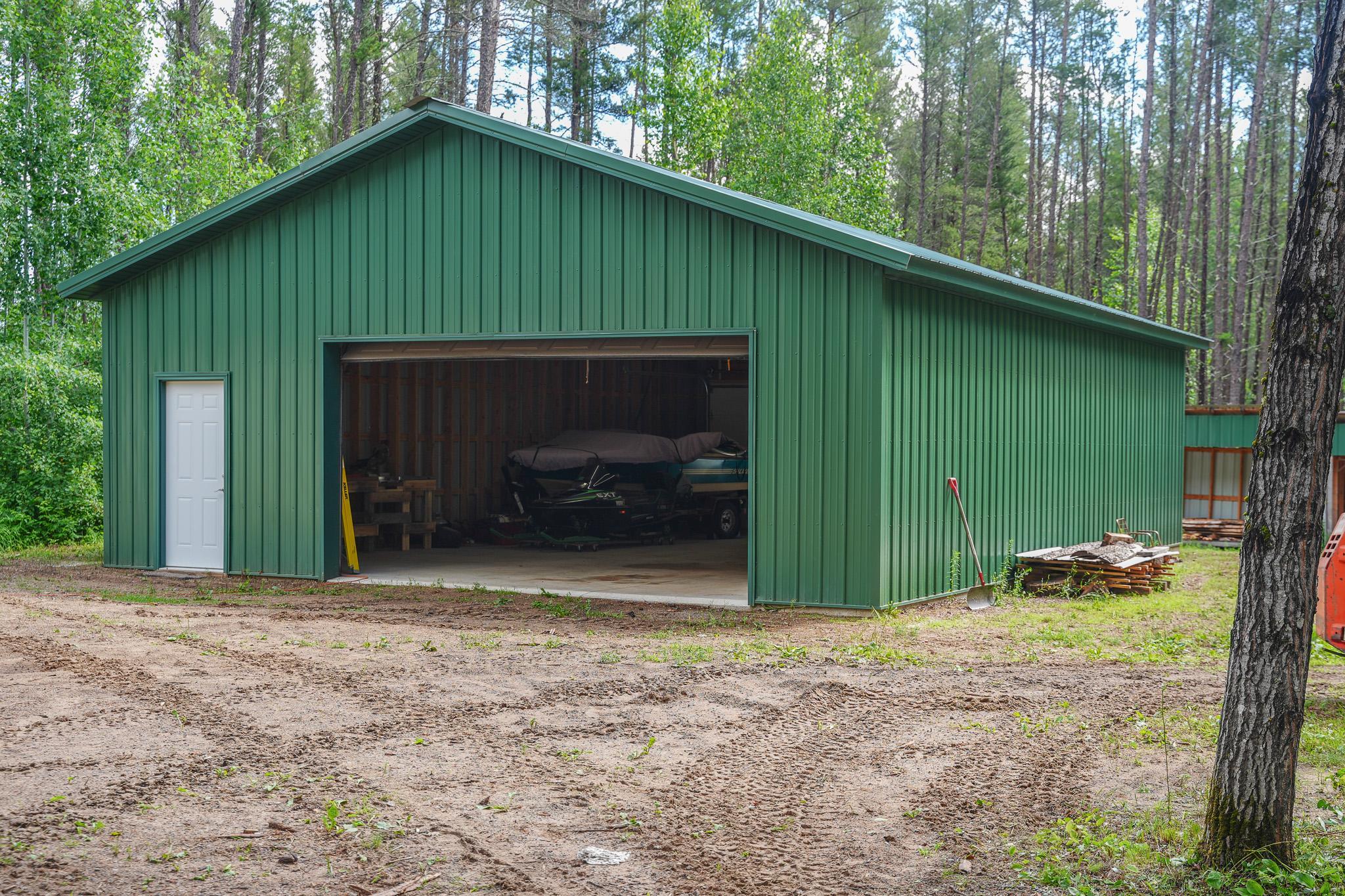 30x40 garage with 10' steel sidewalls, steel roof, 16x9 overhead door and two 9x9 overhead doors in back