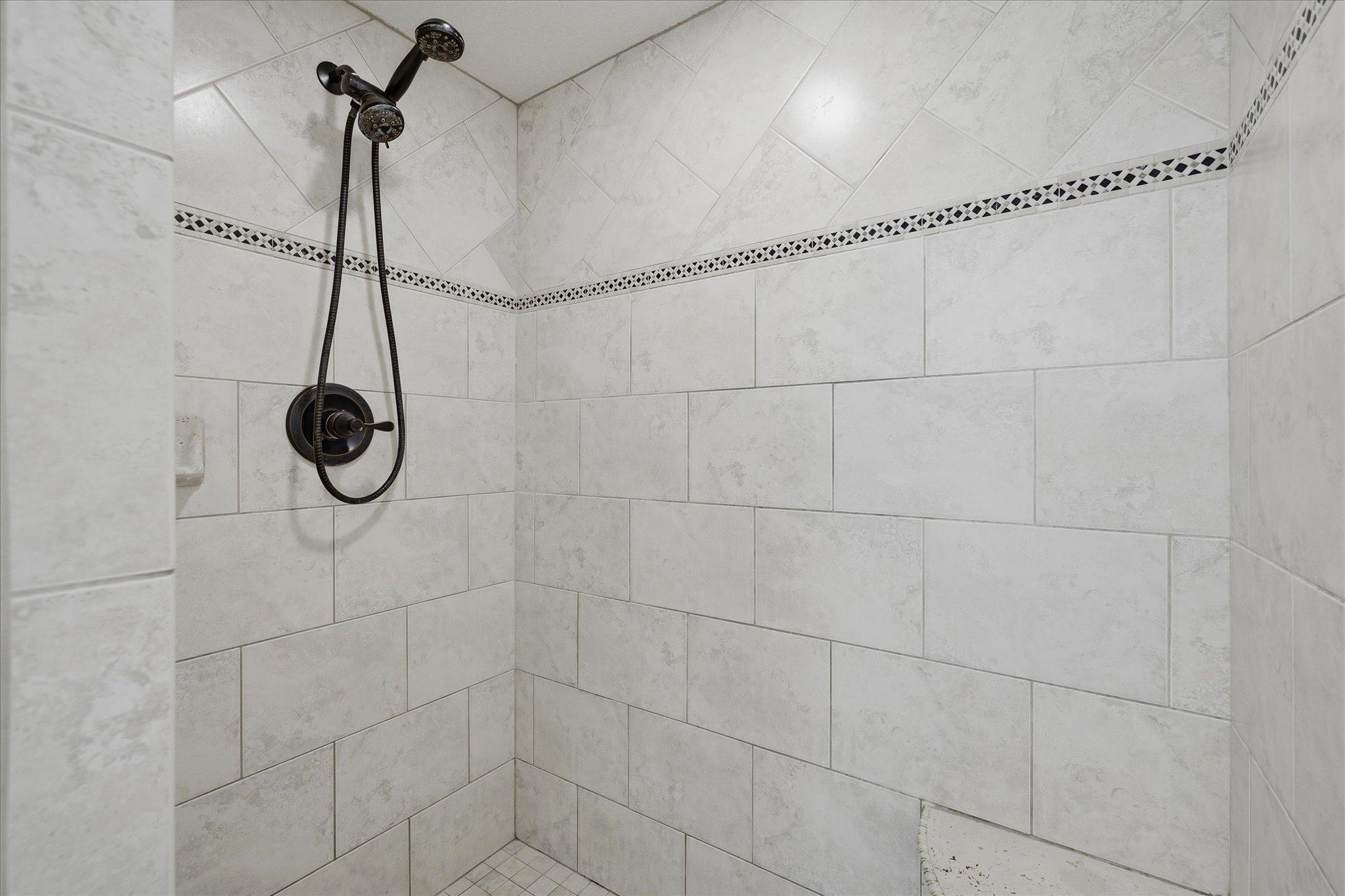 Large tiled walk in shower.