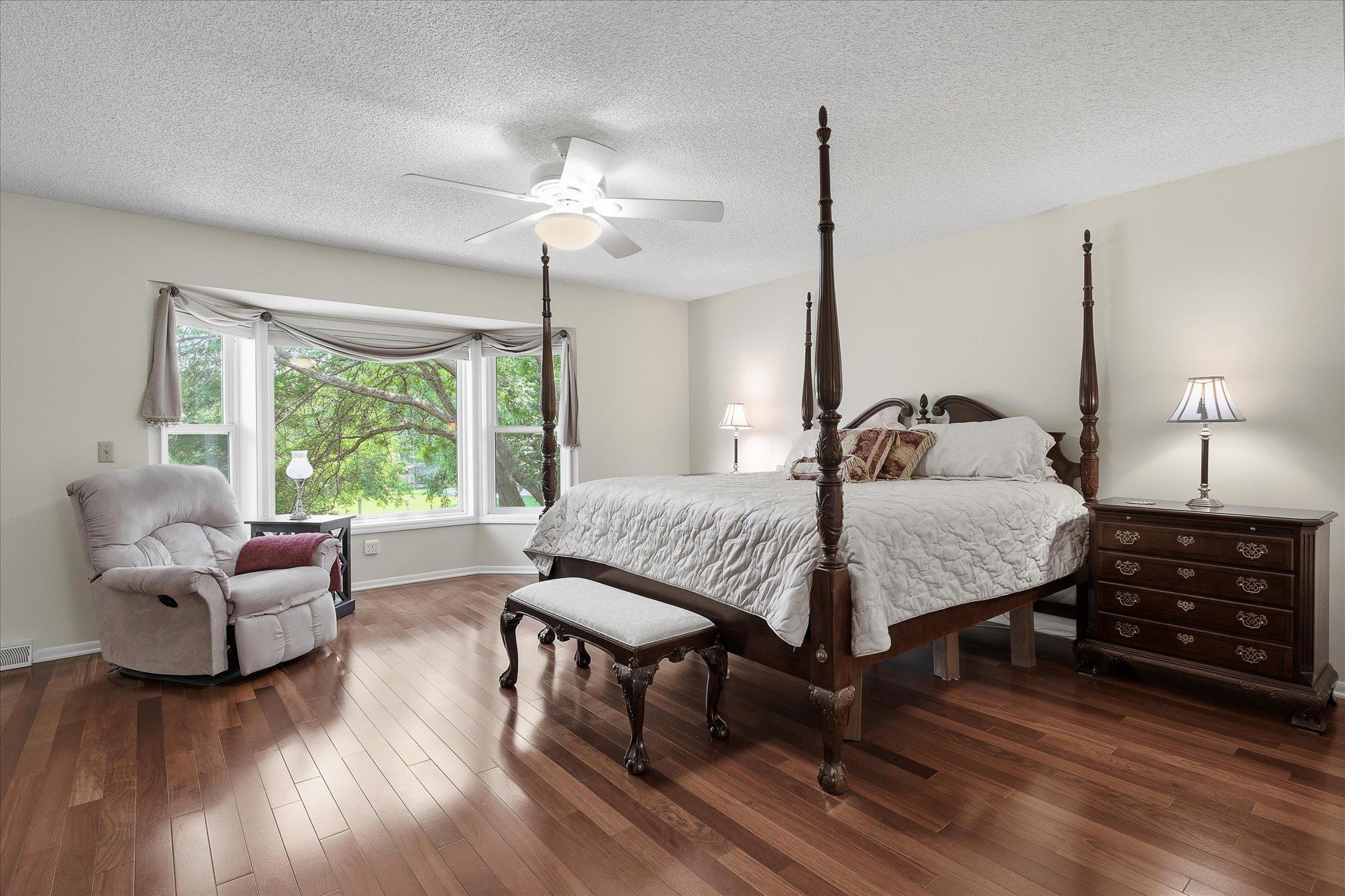 Main bedroom with large windows.