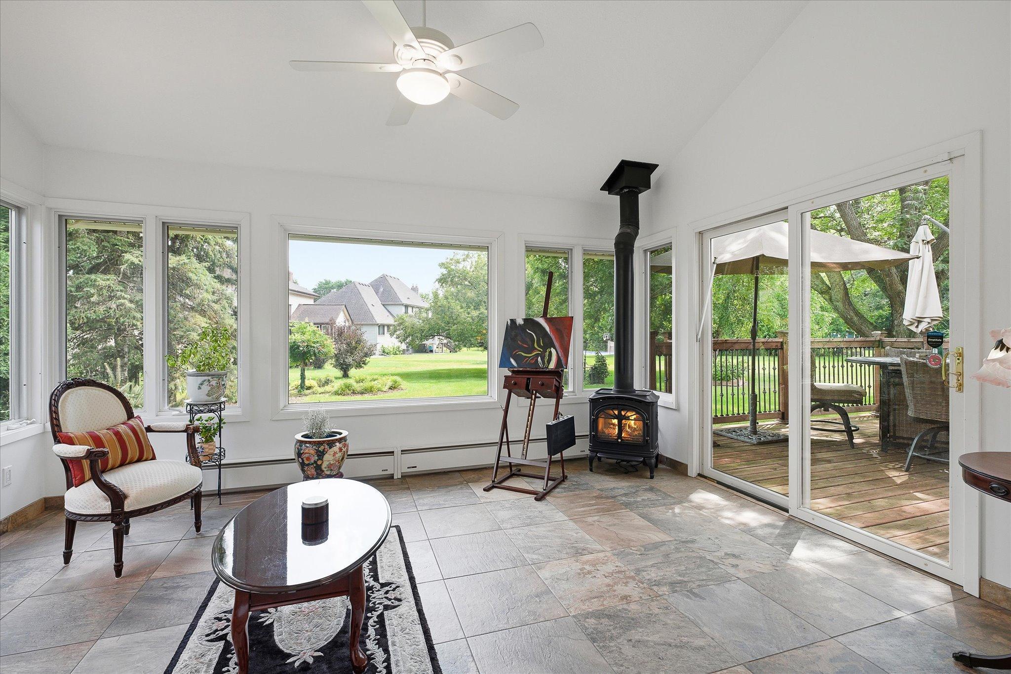 Sunroom off the back of the home provides great site lines to the large backyard.