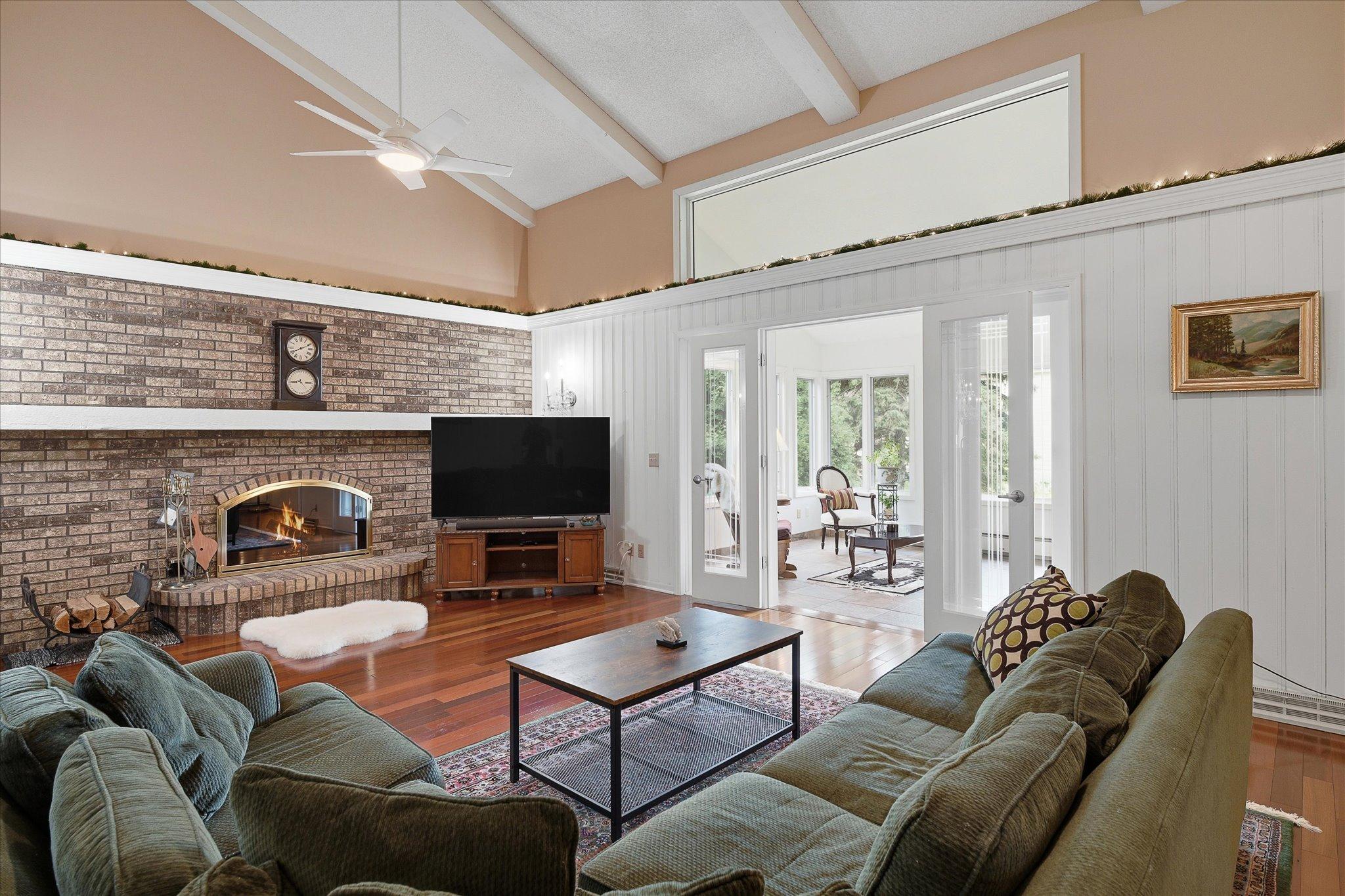 Family room with vaulted ceilings and lovely red cherry wood flooring throughout the main floor.