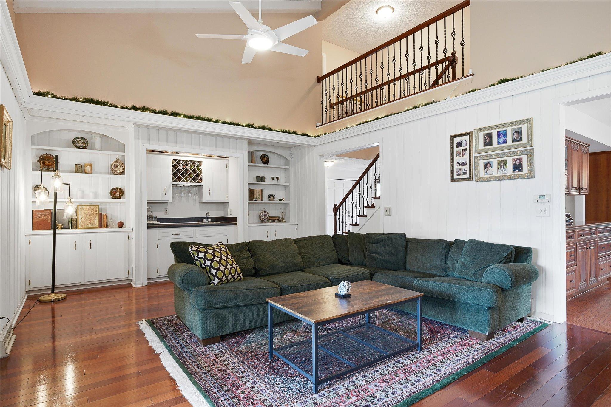 Open staircase leads to upstairs with open railing makes the home feel grand~