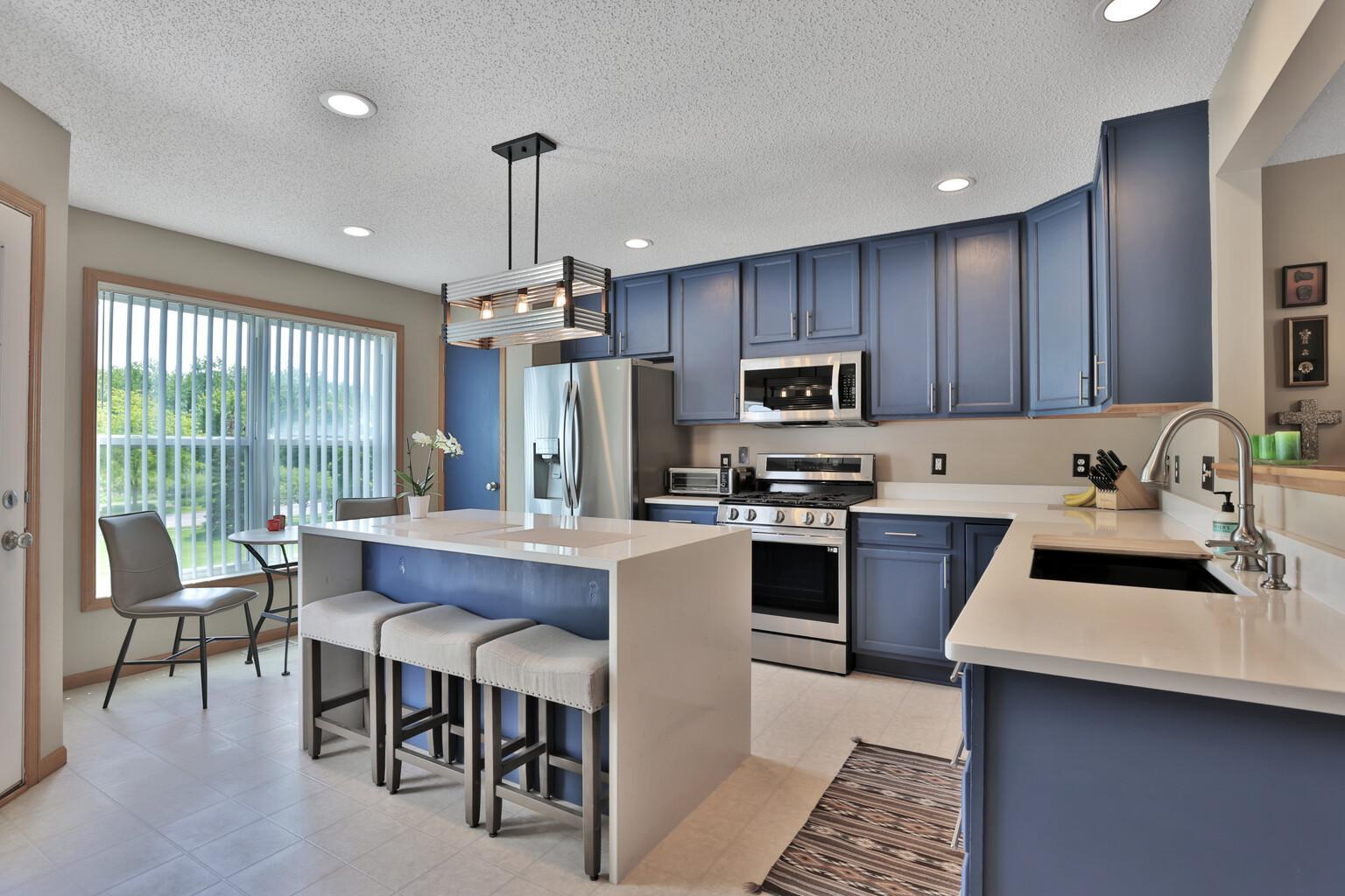 Beautifully updated kitchen with eat up island and roof for small sitting area. Stainless appliances and hard surface tops.
