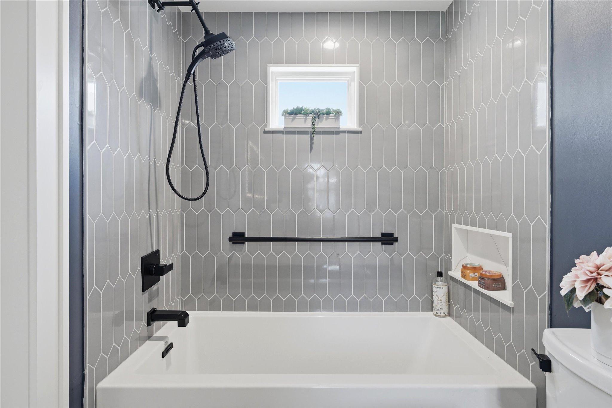 Tiled tub surround in the primary suite