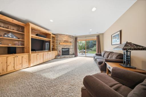 The walkout lower level is designed for entertaining with a beautiful bar, fireplace, custom built-ins, abundant storage, and even a hidden space tucked behind a bookshelf.