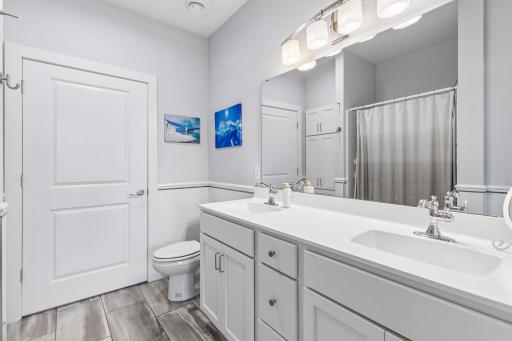 Primary suite with walk in shower, closet and laundry