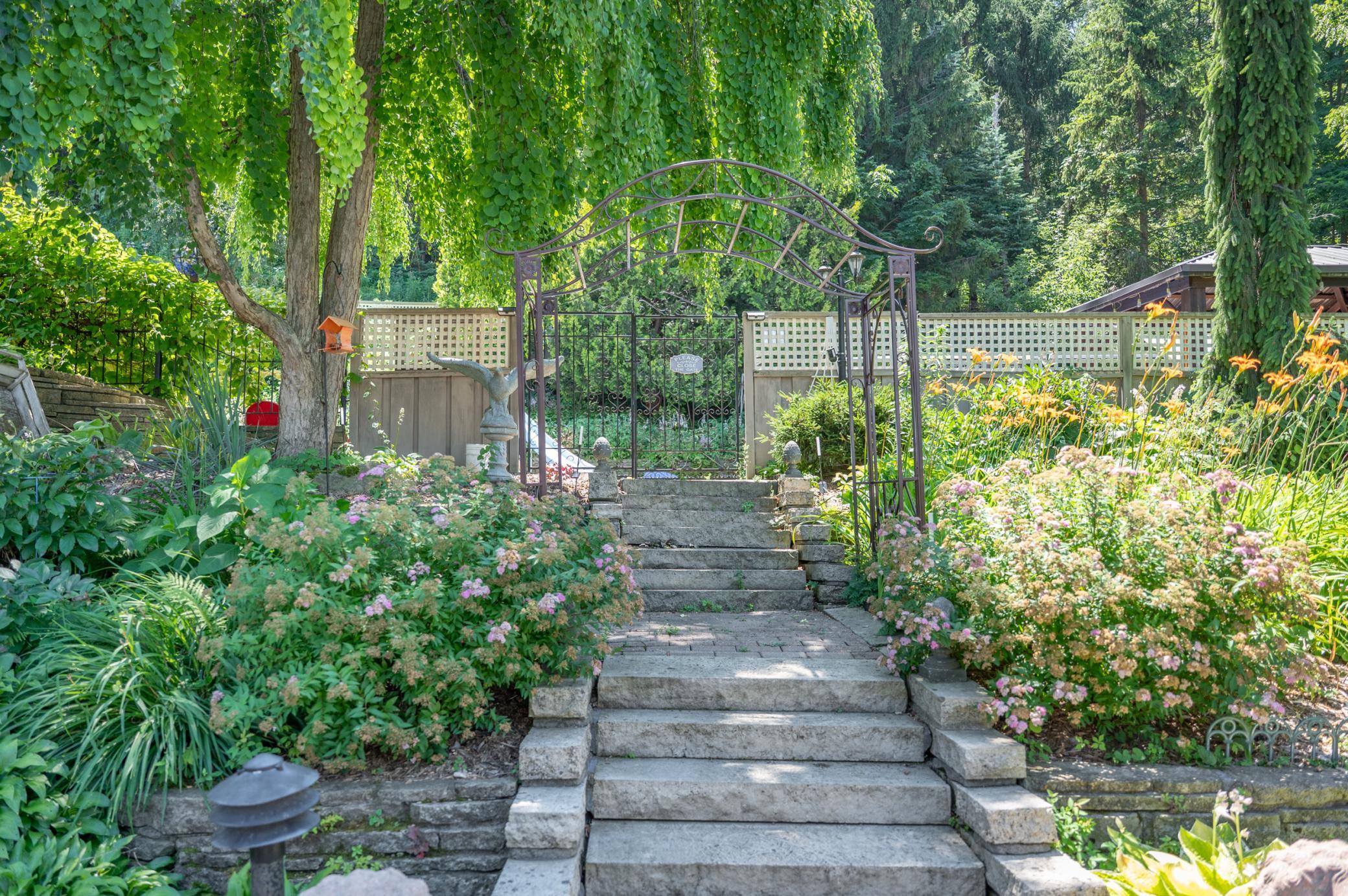 Lovingly tended plants and stone stairs crisscross the hillside grounds.