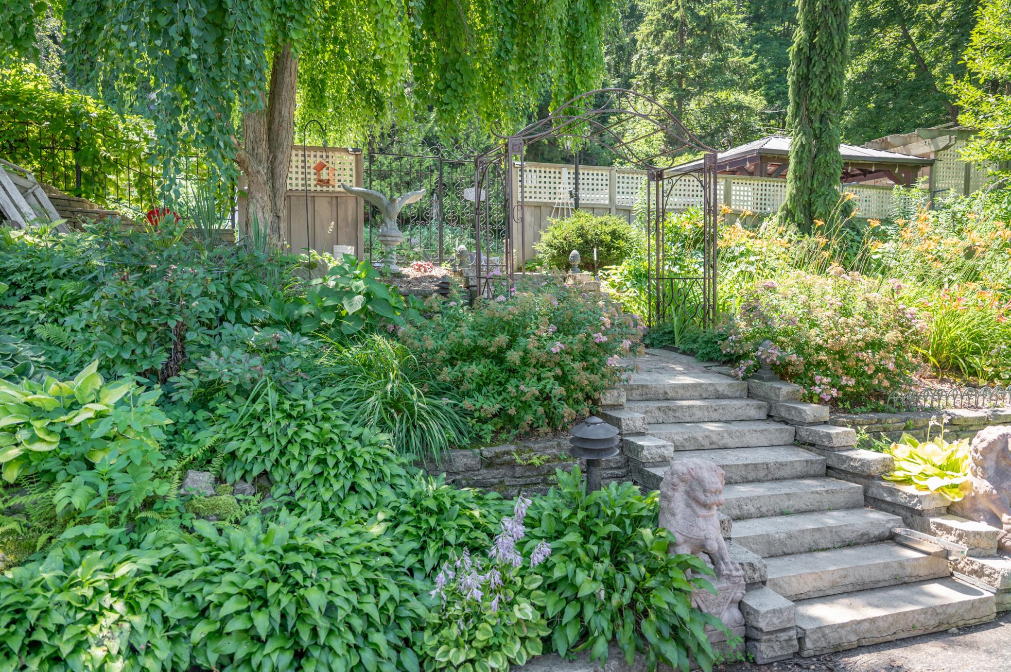 Well considered perennials fill out the green space in back and give a fairytale feel to the backyard.