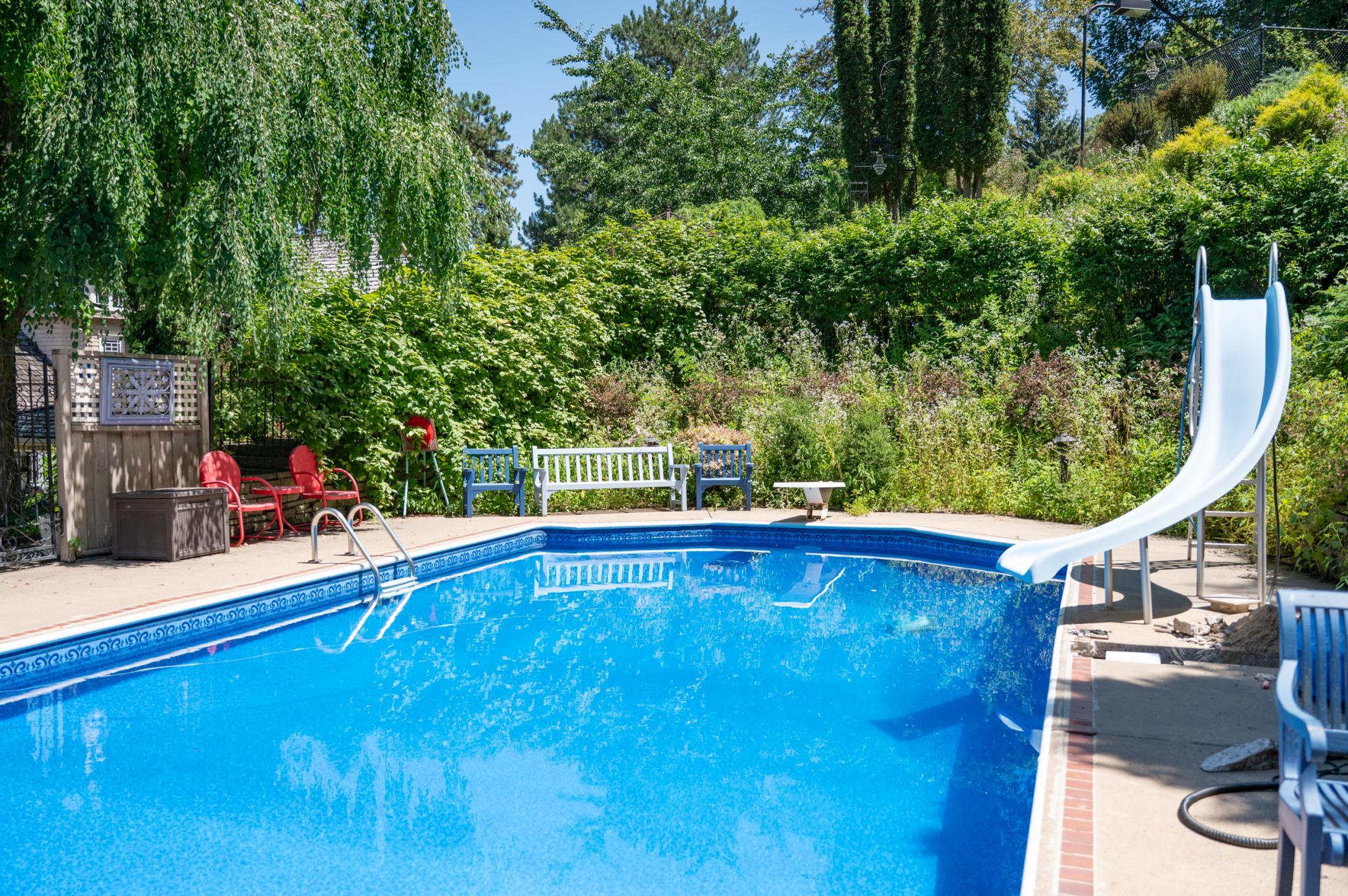 The various plantings make the pool area like an oasis, though swimmers will most likely be more impressed by the diving board and slide.