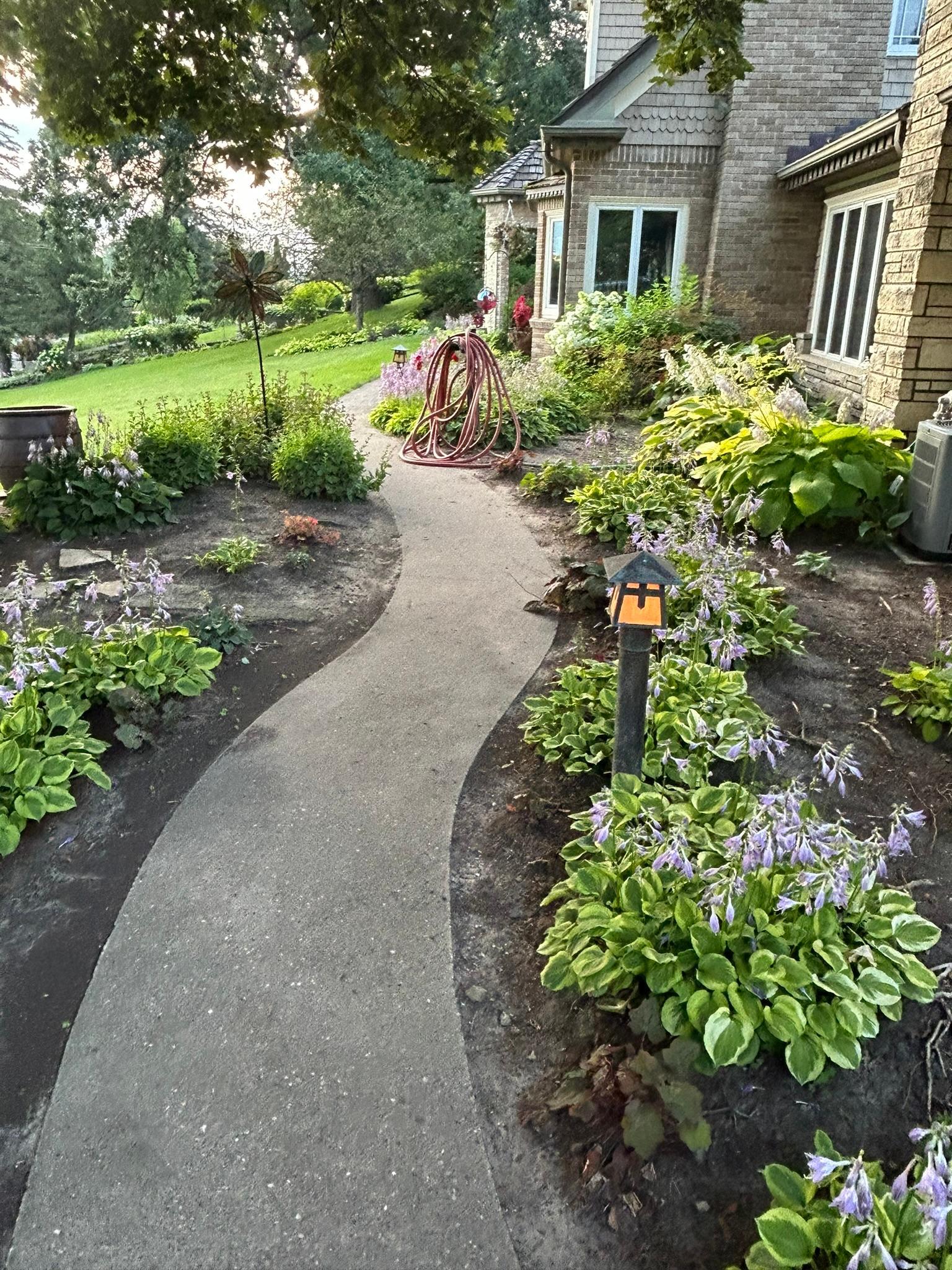 Many wonderful garden paths dot this estate and feature landscape lighting on timers for an ethereal glow after dusk.