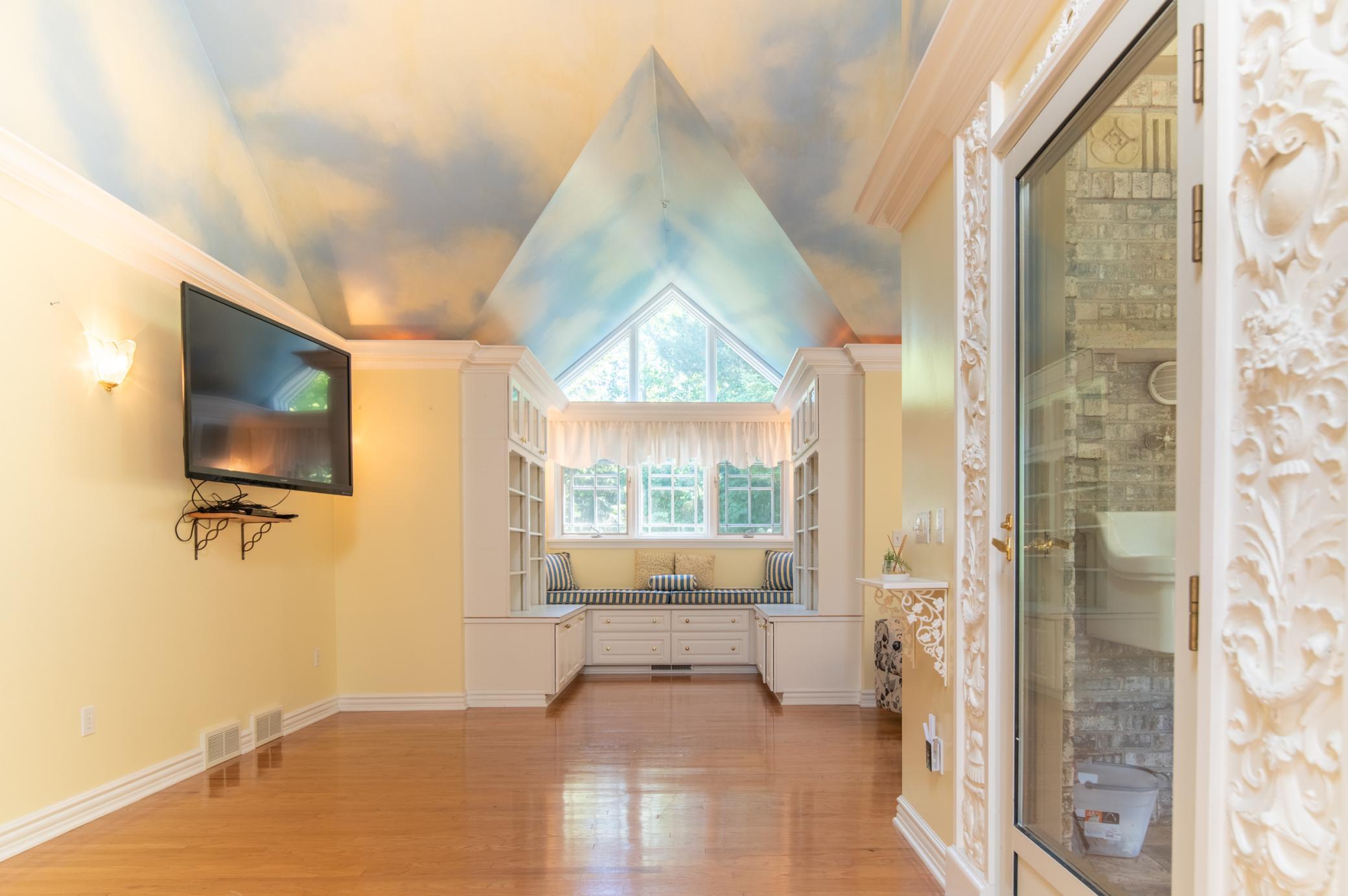Located at the back of the home, this bedroom features a walk-in closet, great built-ins and a storybook feel with vaulted ceilings.