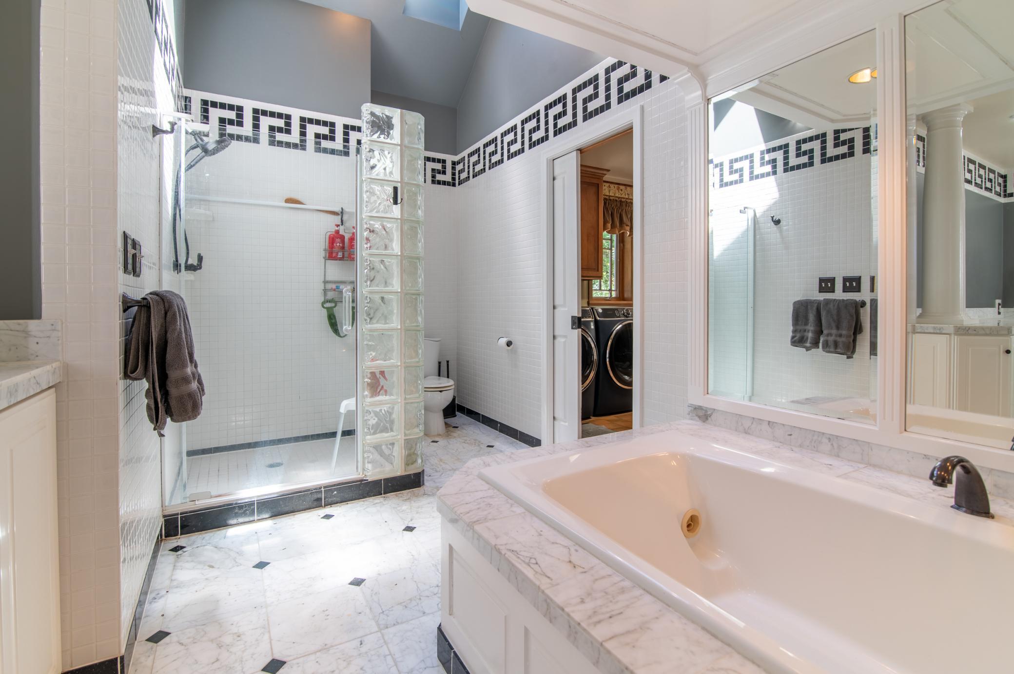 The main floor bath features a spacious shower and jetted tub perfect for starting or ending your day.