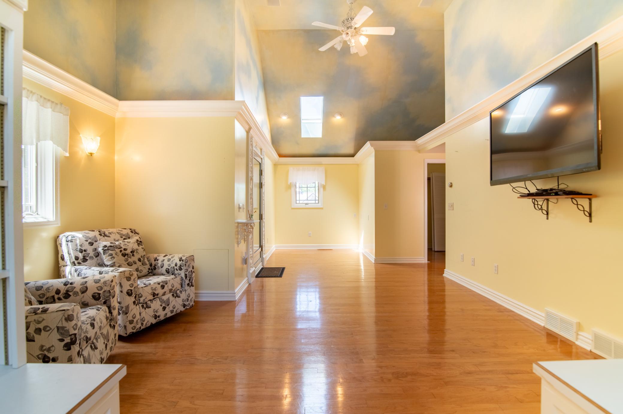 At far right of frame, the walk-in closet provides plenty of storage. The door at left leads to a greenhouse/sunroom.