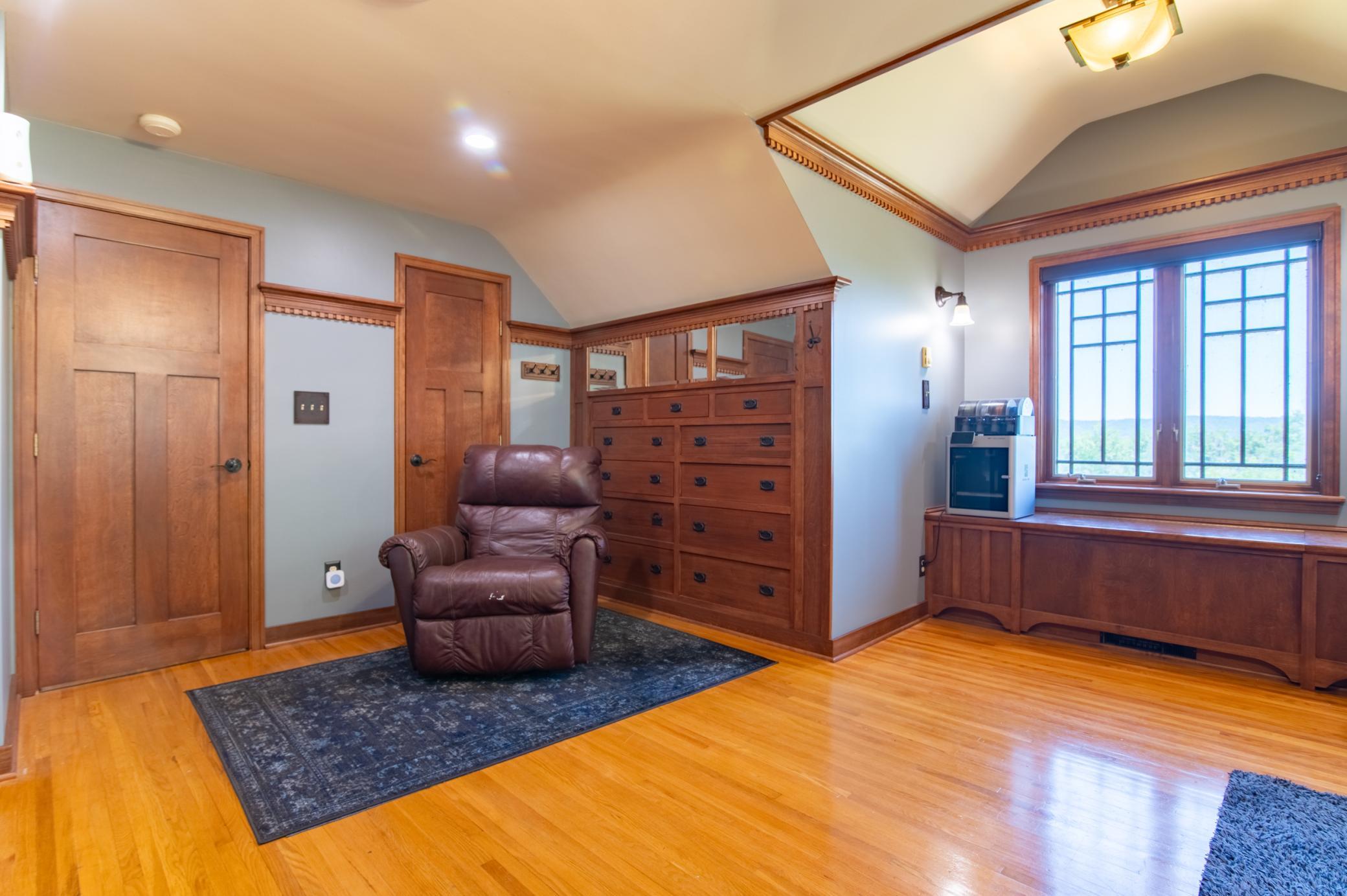 As an office or a bedroom, this upper level room features myriad options for built-in storage and overlooks Lake Winona from the windows seen at right.