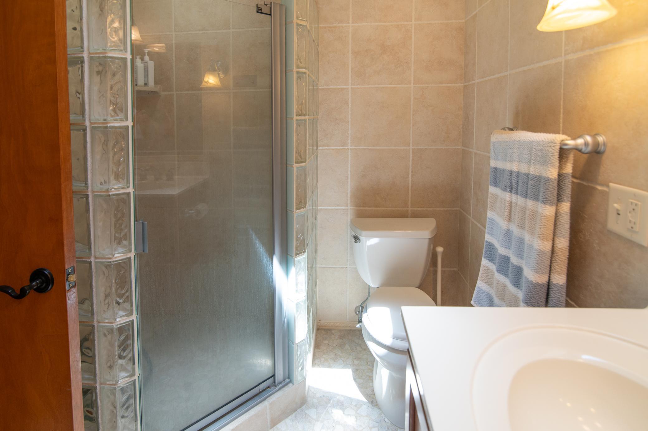 An upper level 3/4 bath leaves the fancy level main bath all to yourself.