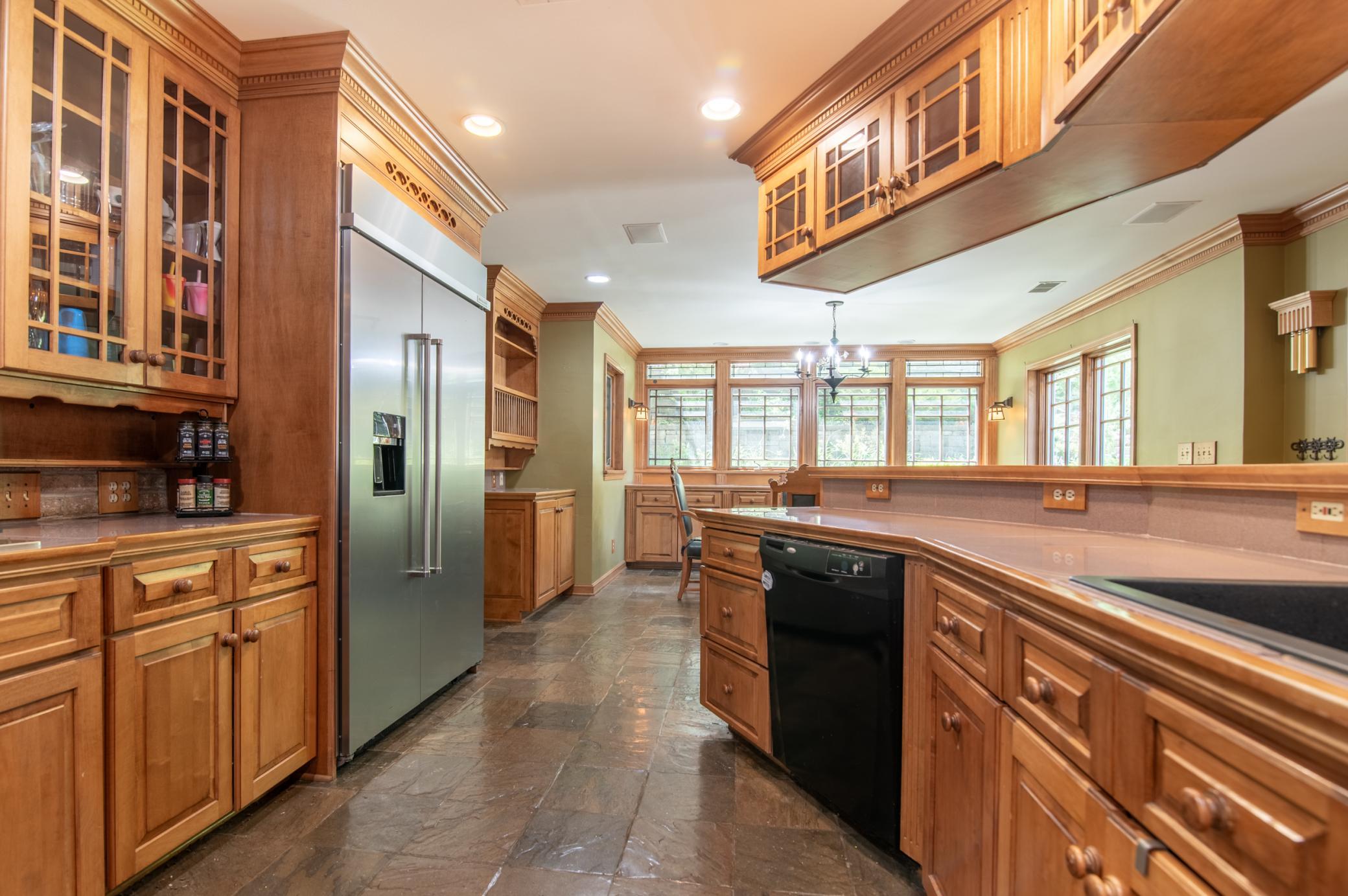 The kitchen and attached dining area are framed by windows on two sides for great views of the backyard.