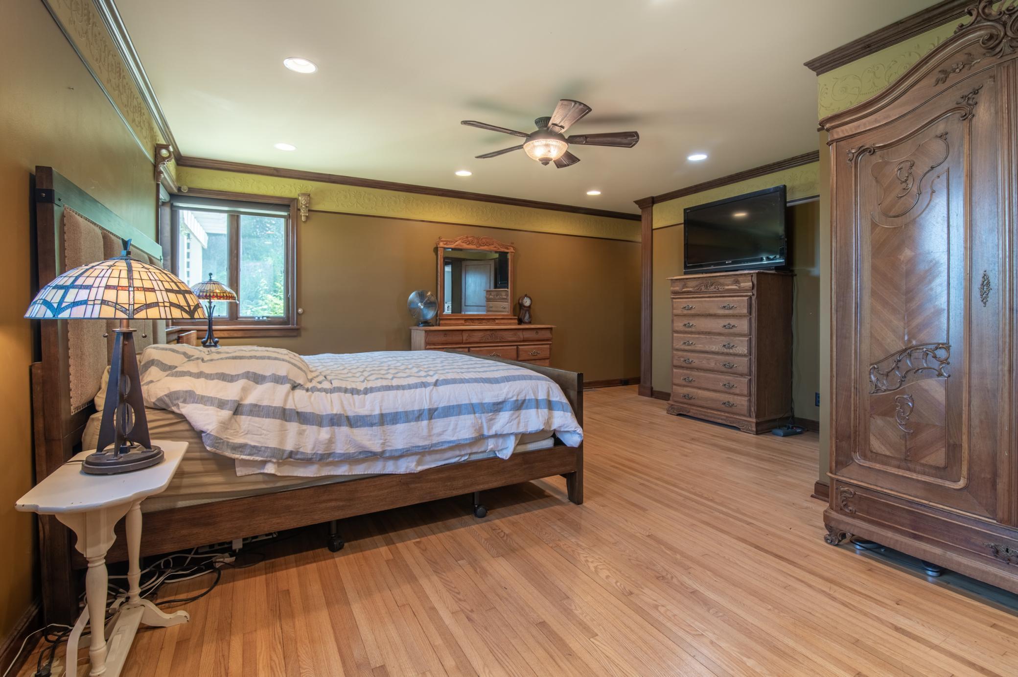 This main level bedroom is perfect as a primary or a spacious guest suite.