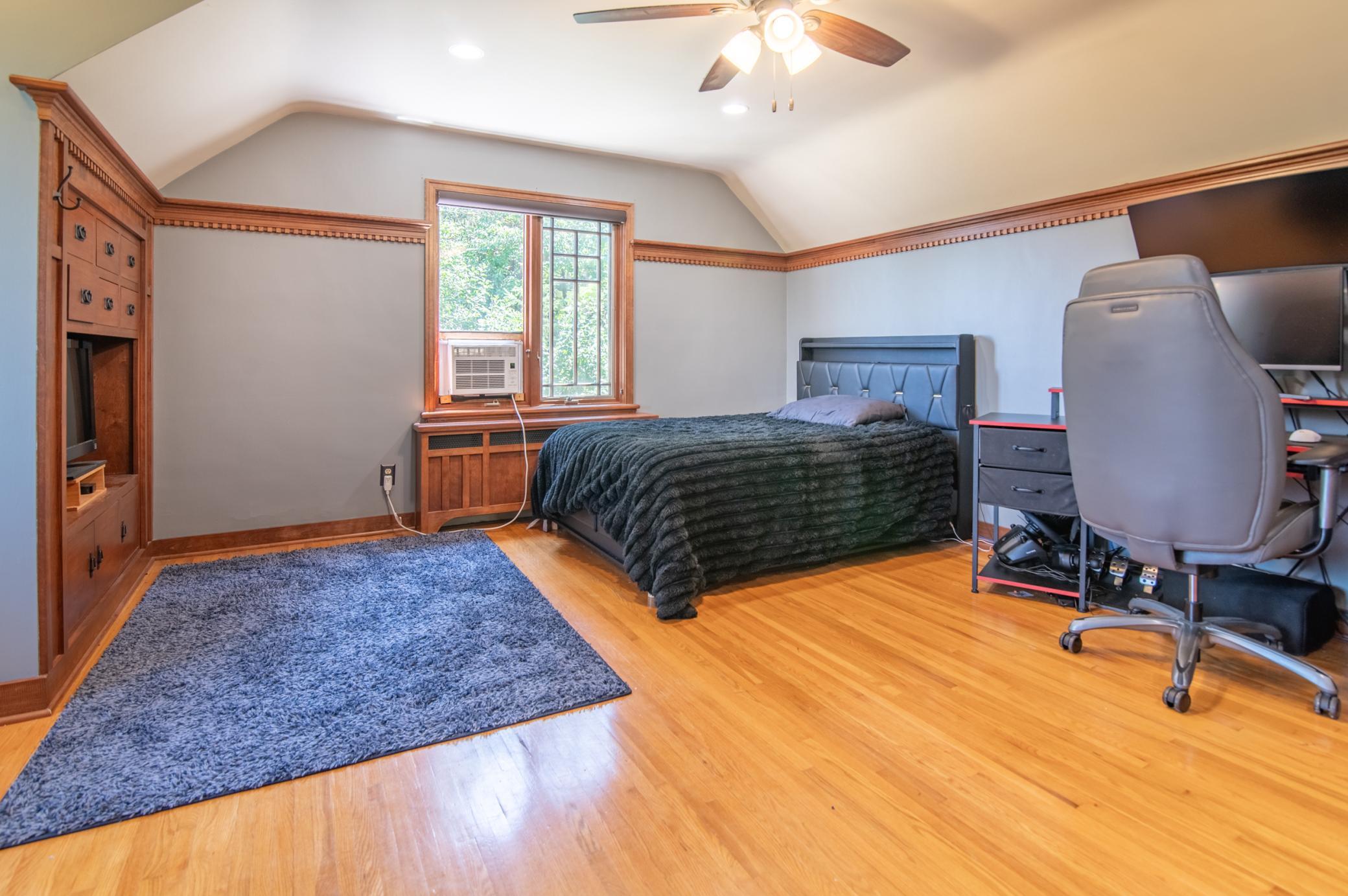 This second floor bedroom has beautiful built-ins and a charming feel with natural woodwork.
