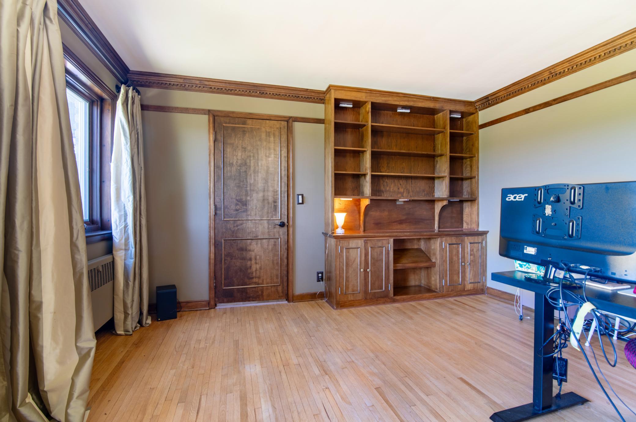 A built-in bookcase, picture rail all around and beautiful woodwork give this room tons of potential to create a rich and vibrant room.