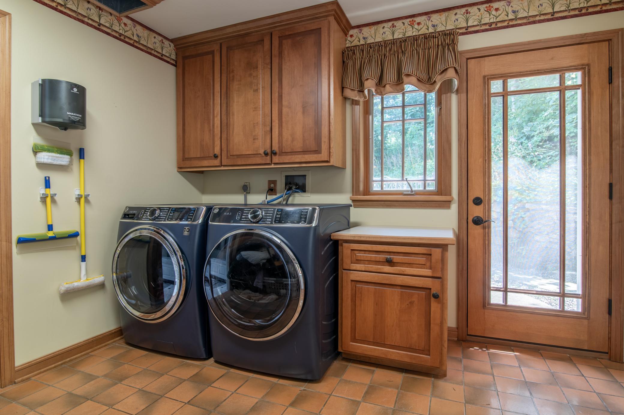 The main level laundry is conveniently located and a spacious place to do chores (or shut them away when company comes).