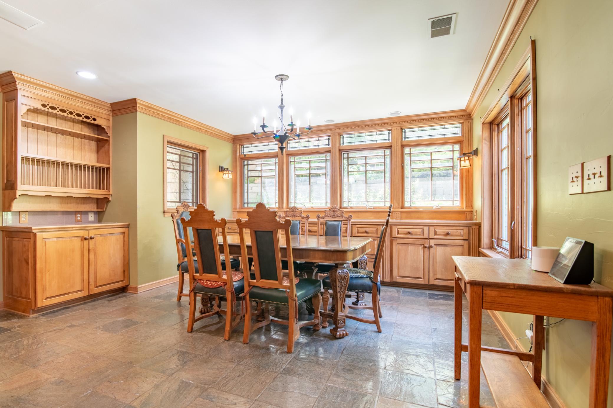 Storage for dishes, serving ware and more abound in the cabinets in the eating area of the kitchen.