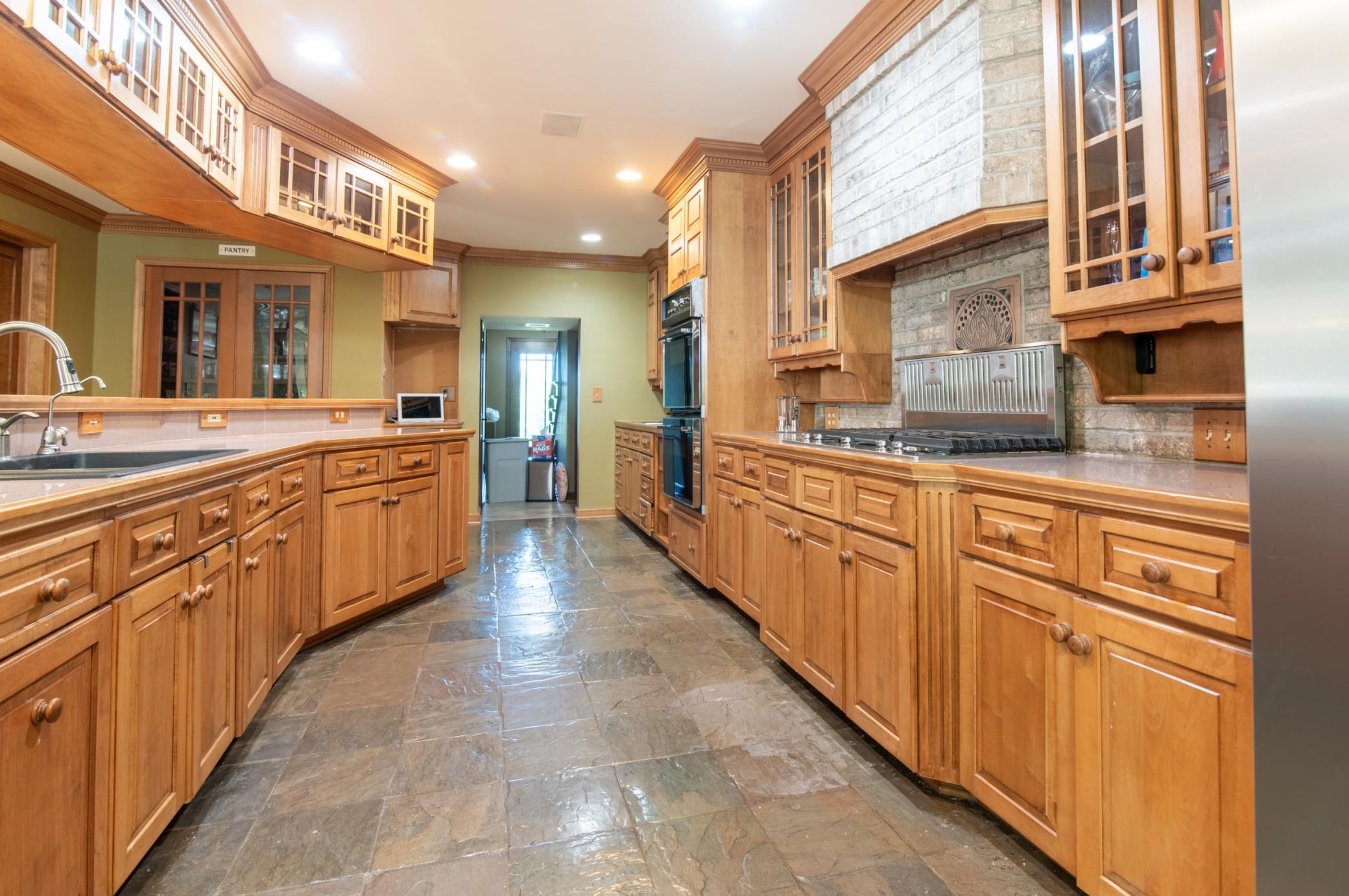 A walk-in pantry just beyond the center island boasts plenty of room for your daily needs.