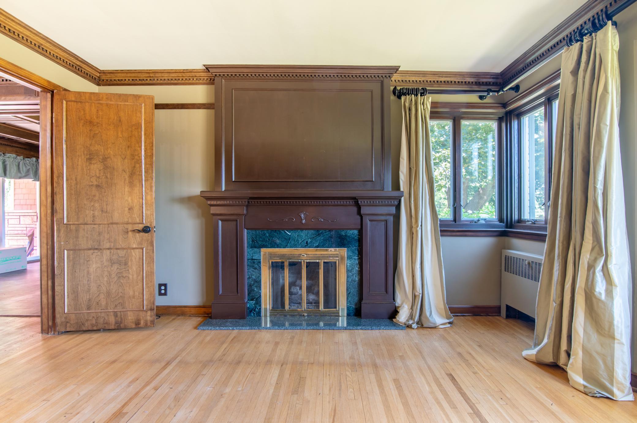 This classic fireplace in the front room has been converted to gas for a classic touch with a modern interpretation.