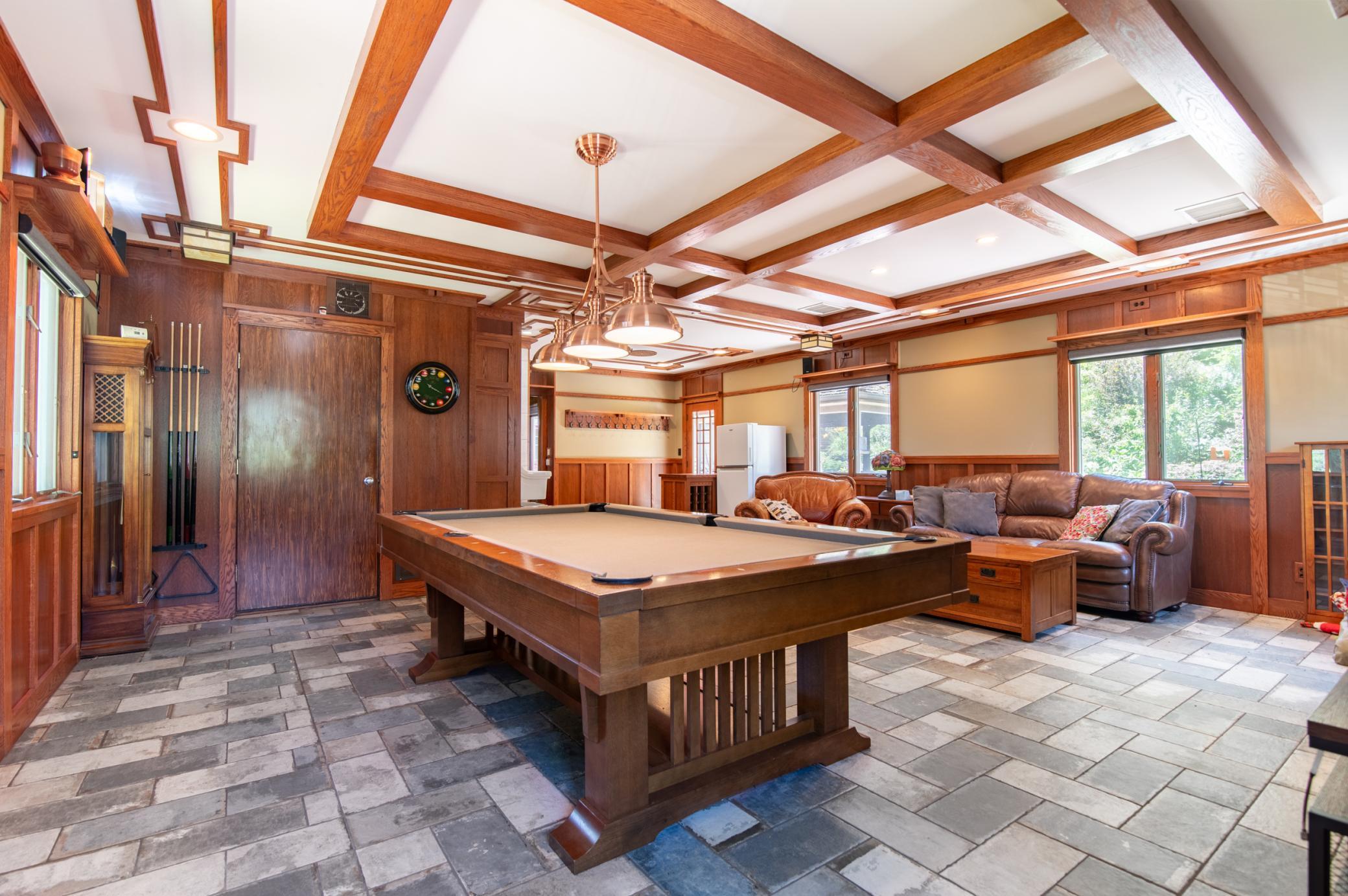 Custom tile was recently added to this space which is often used as a break from swimming during the summer months. The door at the back leads to the pool and just out of frame is a bathroom and shower perfect for rinsing off after a swim.