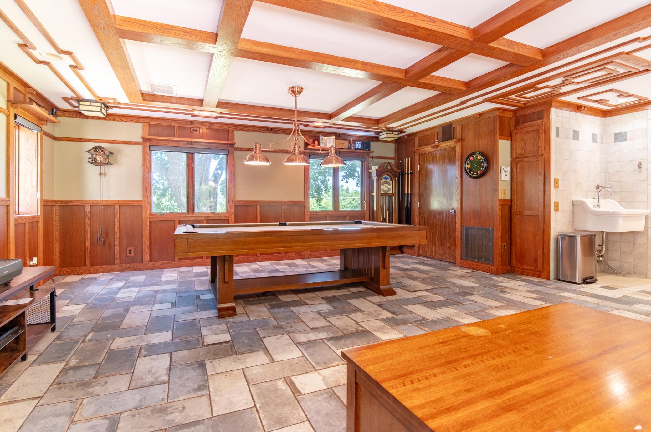 The door at the rear of the pool table leads to the utilities for much of the home - in floor radiant heat, new combi boiler and water storage are controlled by multiple zones. The large sink originally came from the Winona hospital.