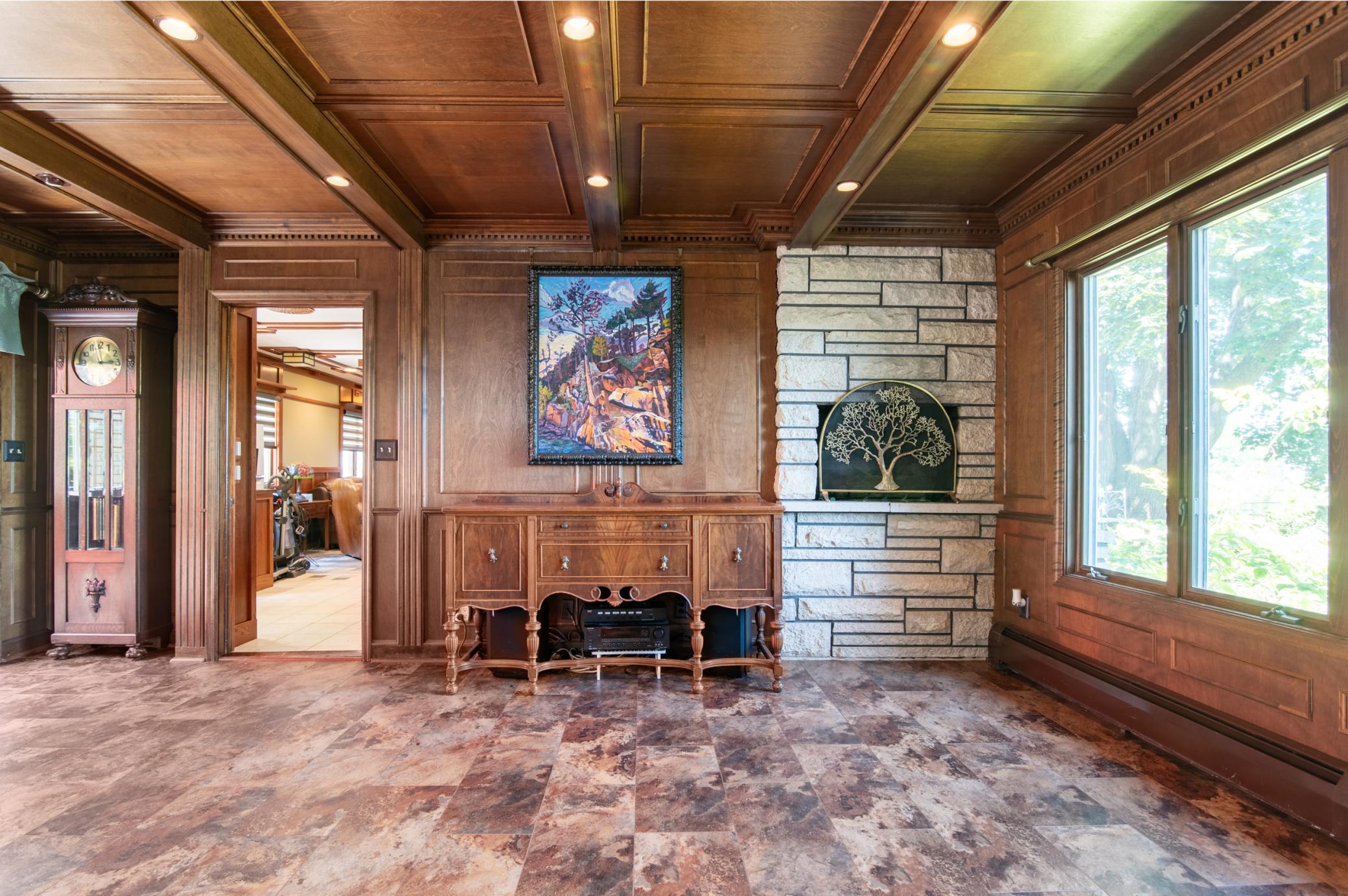 As in other rooms, natural woodwork and a picture rail abound in the main level living spaces.