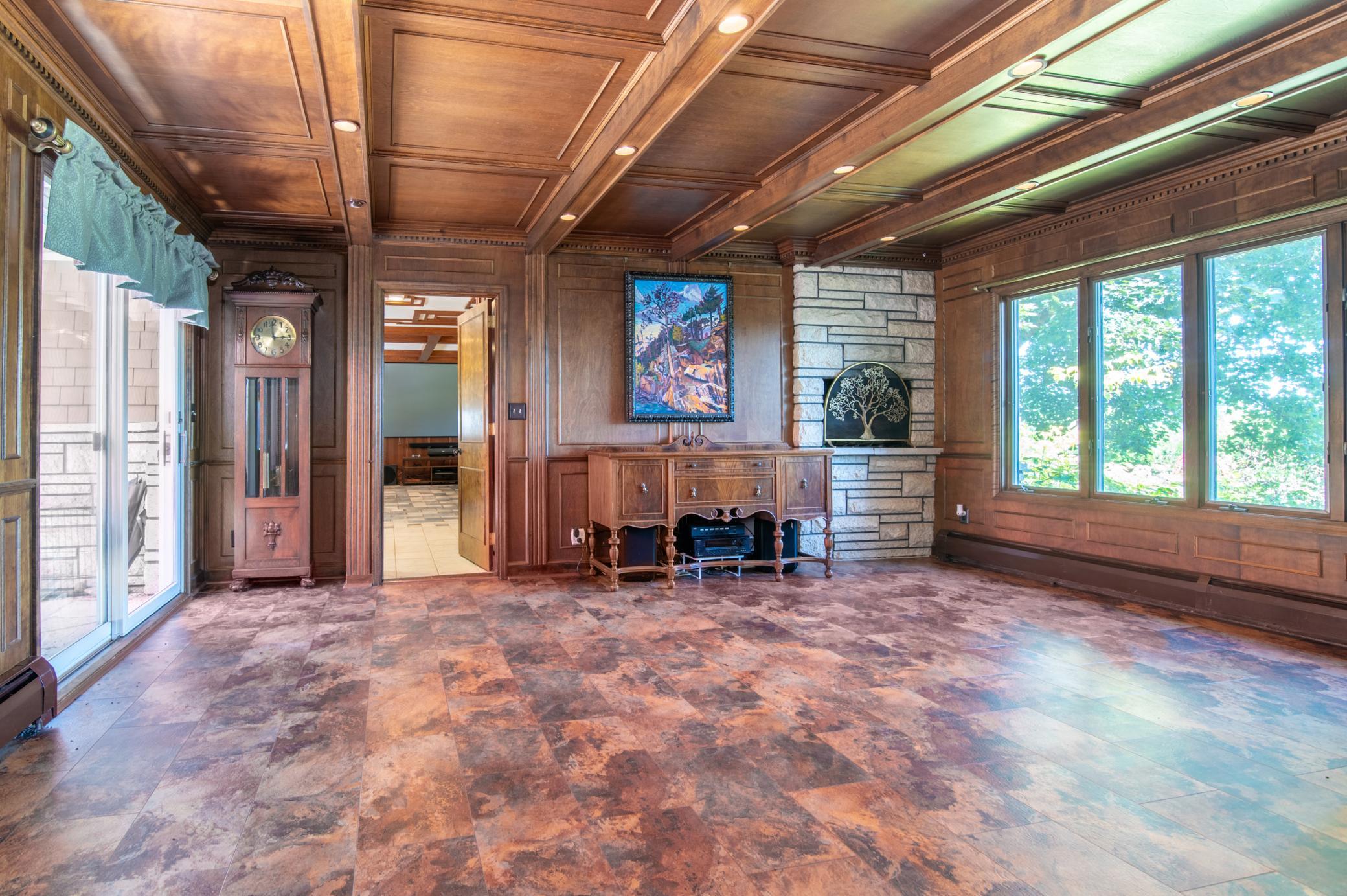 The fireplace to the left of the far windows has been converted to gas and the sliding door at left opens to the back patio.