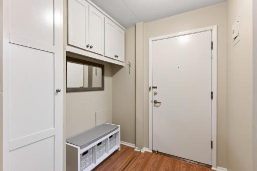 The generous sized foyer has a custom built in hanging closet and cabinets for storage.
A great space for a sitting bench too!