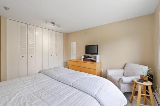 A 12 foot bank of closets offers plenty of hanging space and storage.
