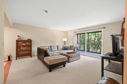 Spacious living room, all decorated in neutral tones. Complimented by loads of natural light streaming in from the lovely screened porch!