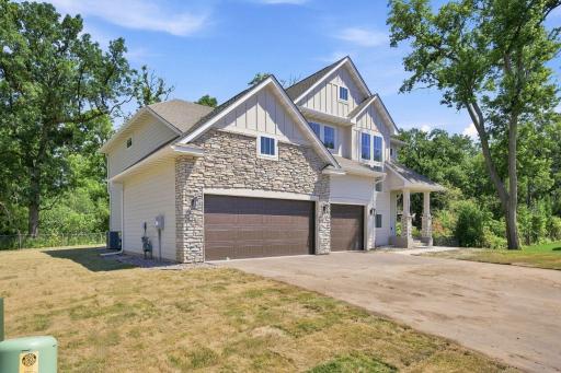 Custom-designed and newly built in 2025! Front exterior view of the property from an angle. Showcasing exceptional craftsmanship and thoughtful design throughout.