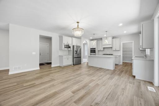 Another view of the kitchen and informal dining area, showcasing the open layout and the convenient entry/mudroom connecting the garage to the home.
