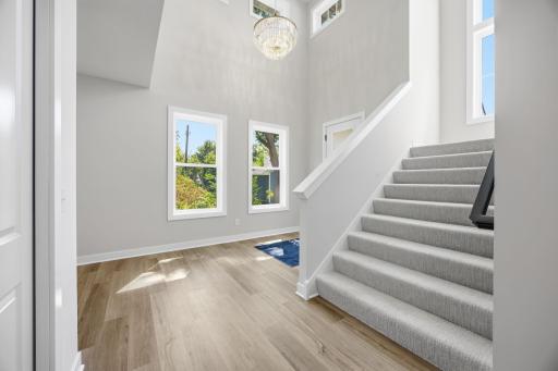 The spacious staircase provides an elegant transition to the second floor.