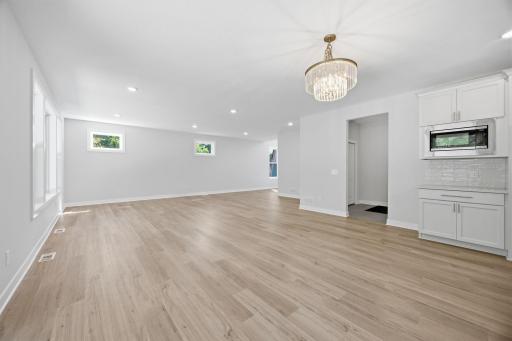 Another view from the foyer highlights the home's open layout, connecting the living room, informal dining area, and kitchen.