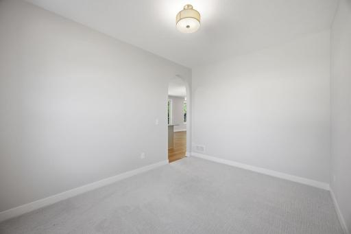 Unfurnished formal dining room adjacent to the kitchen, highlighting the space's versatility for entertaining and everyday use.