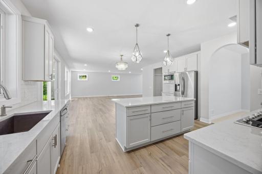 A center island in the kitchen with abundant storage and shelving,