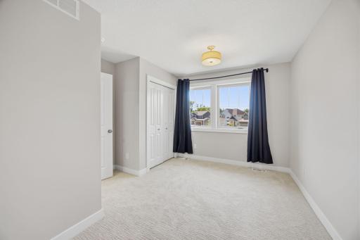Another View of the Upper-Level Bedroom #3 Featuring Generous Space and Natural Light