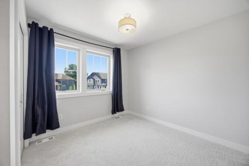 Upper-Level Bedroom #3 Featuring Generous Space and Natural Light