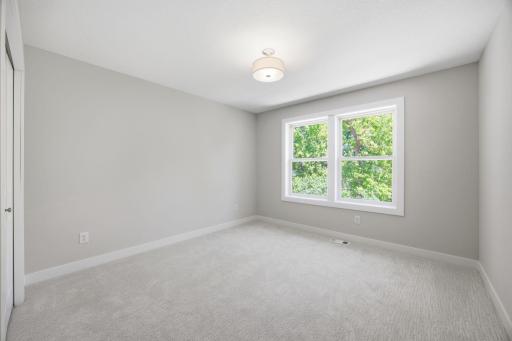 Upper-Level Bedroom #2 Featuring Generous Space and Natural Light
