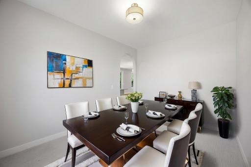 Formal dining room conveniently located adjacent to the kitchen, perfect for hosting family dinners and special occasions. Professionally Virtually Staged.