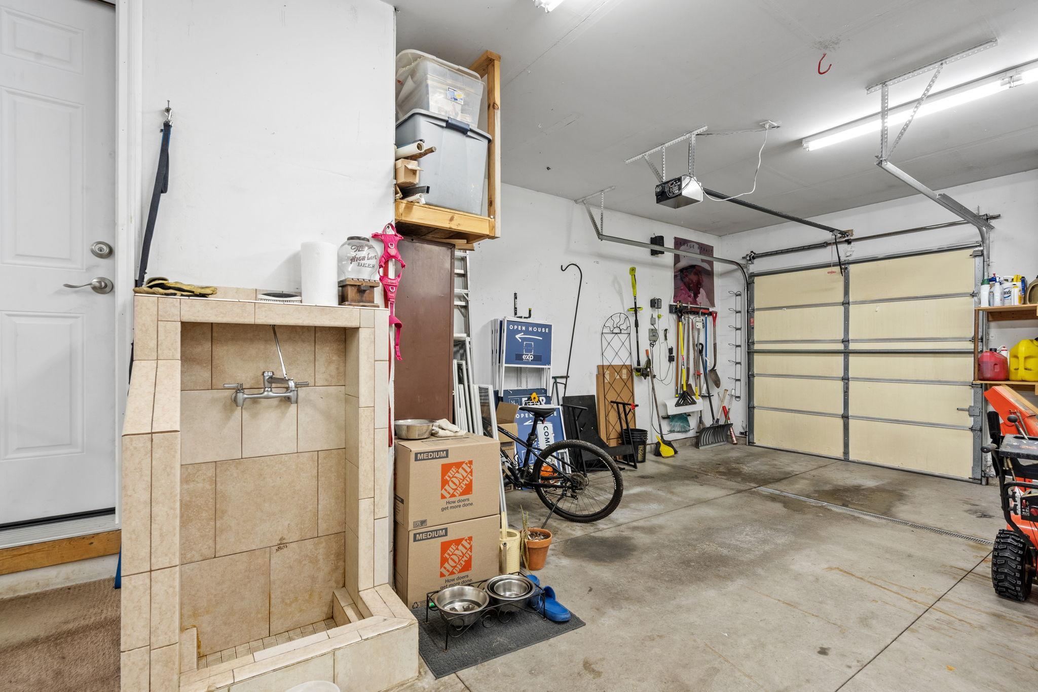Designed for functionality with floor drain, utility sink, and ample room for storage and workspace.