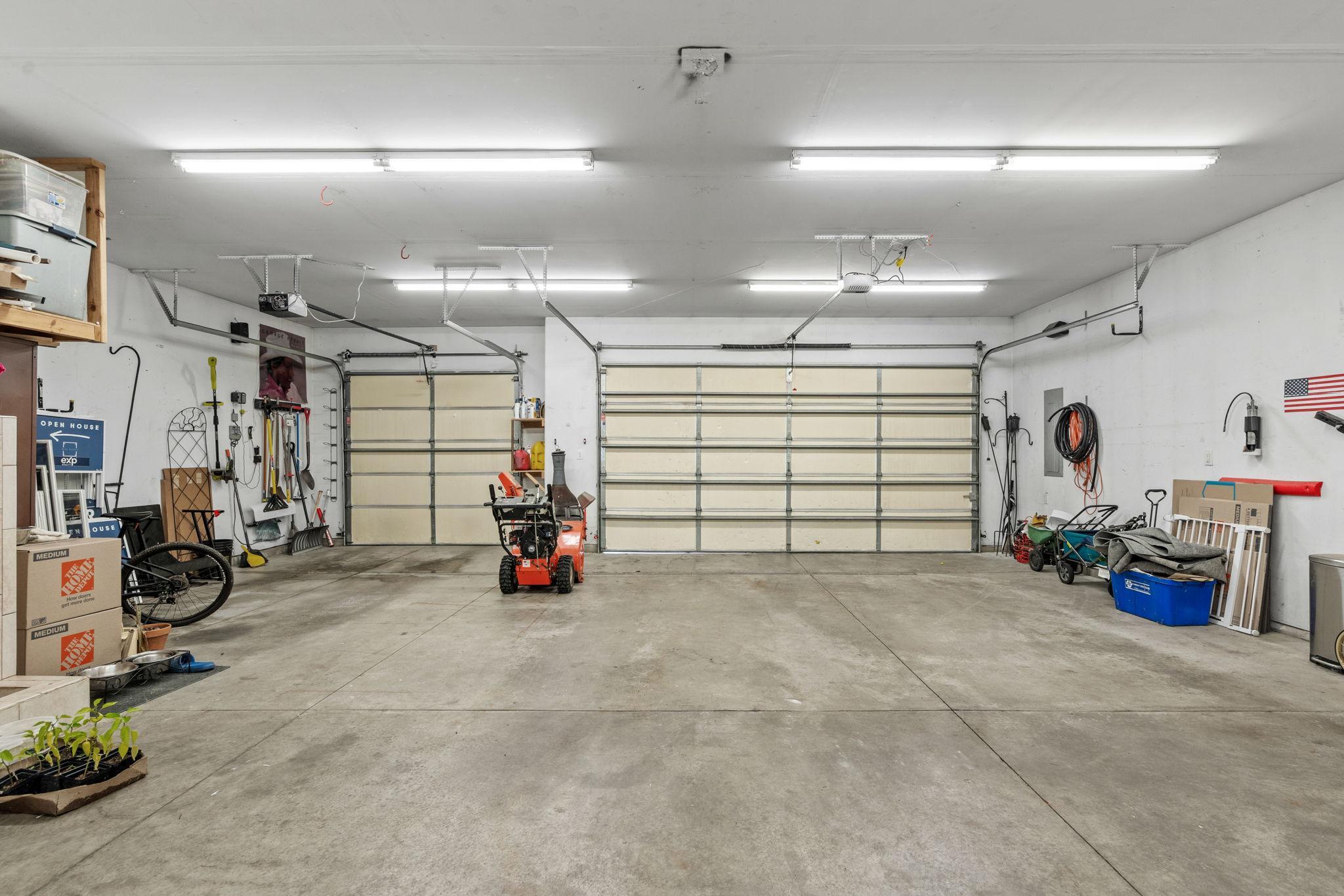 An incredible heated 5-stall garage offering exceptional space for vehicles, recreational toys, hobbies, and workshop projects.