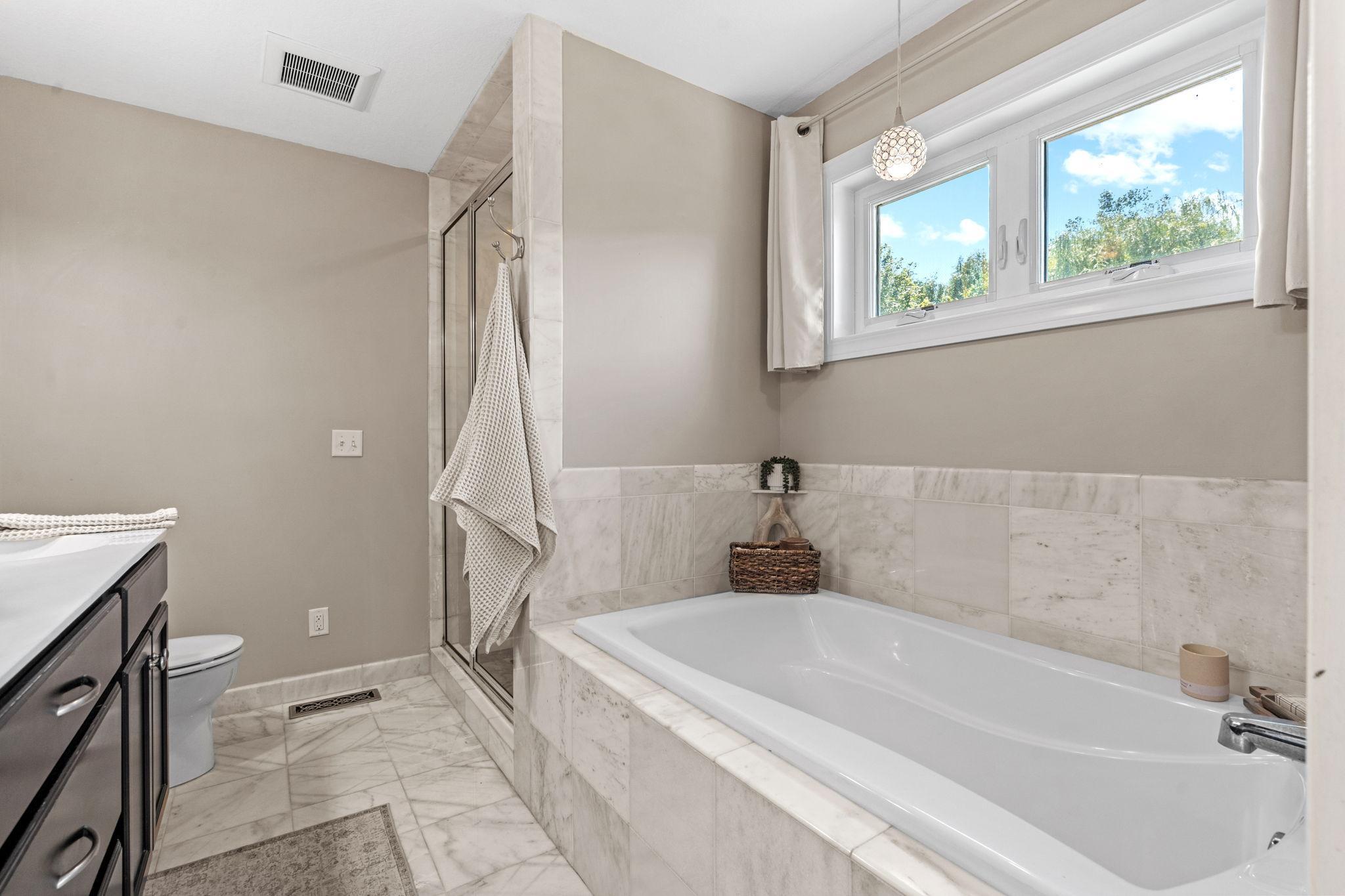 Soaking tub and separate shower.