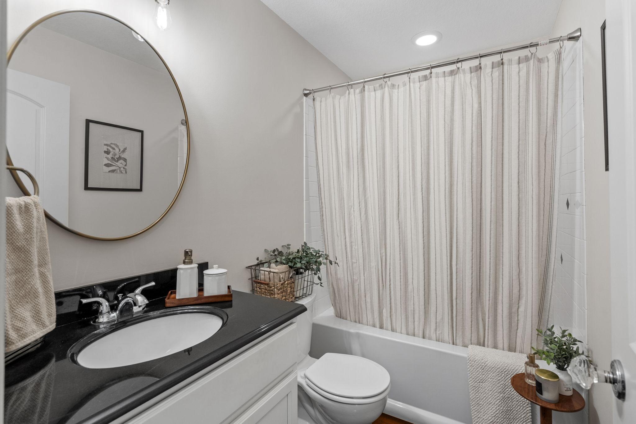 Thoughtfully placed full bath off the hallway from the garage.
