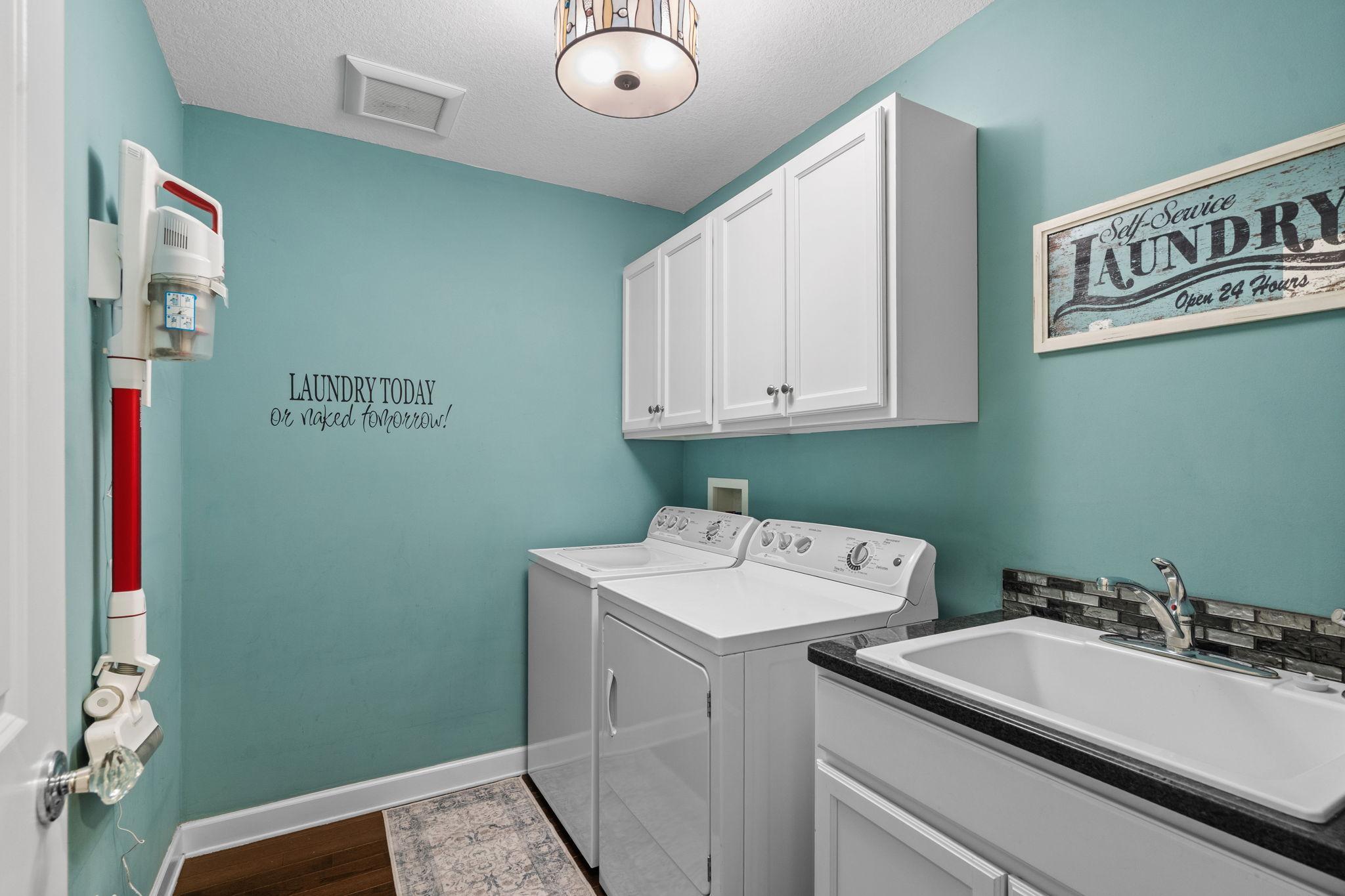 Convenient main-level laundry room with built-in storage.