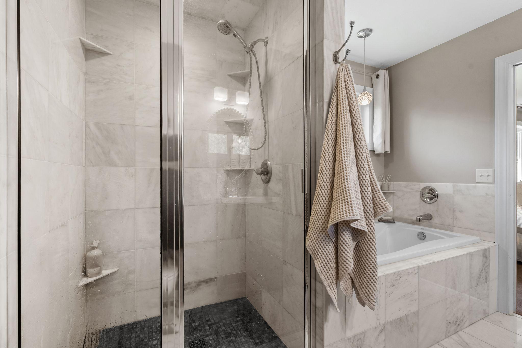 Walk-in shower with timeless tile surround.